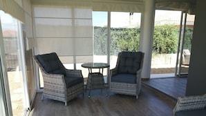 A covered patio area with wicker furniture, including two chairs and a small table. - Villa - Sleeps 4 - Pool - Patio - Parking (Arboleas)