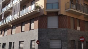 A multi-story building with balconies, a car parked in front, and a no entry sign. - Stunning 2-bed Apartment in Pego (Pego)