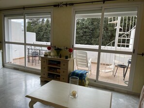 Relax in this serene room with a patio, featuring a table and chairs for outdoor seating.