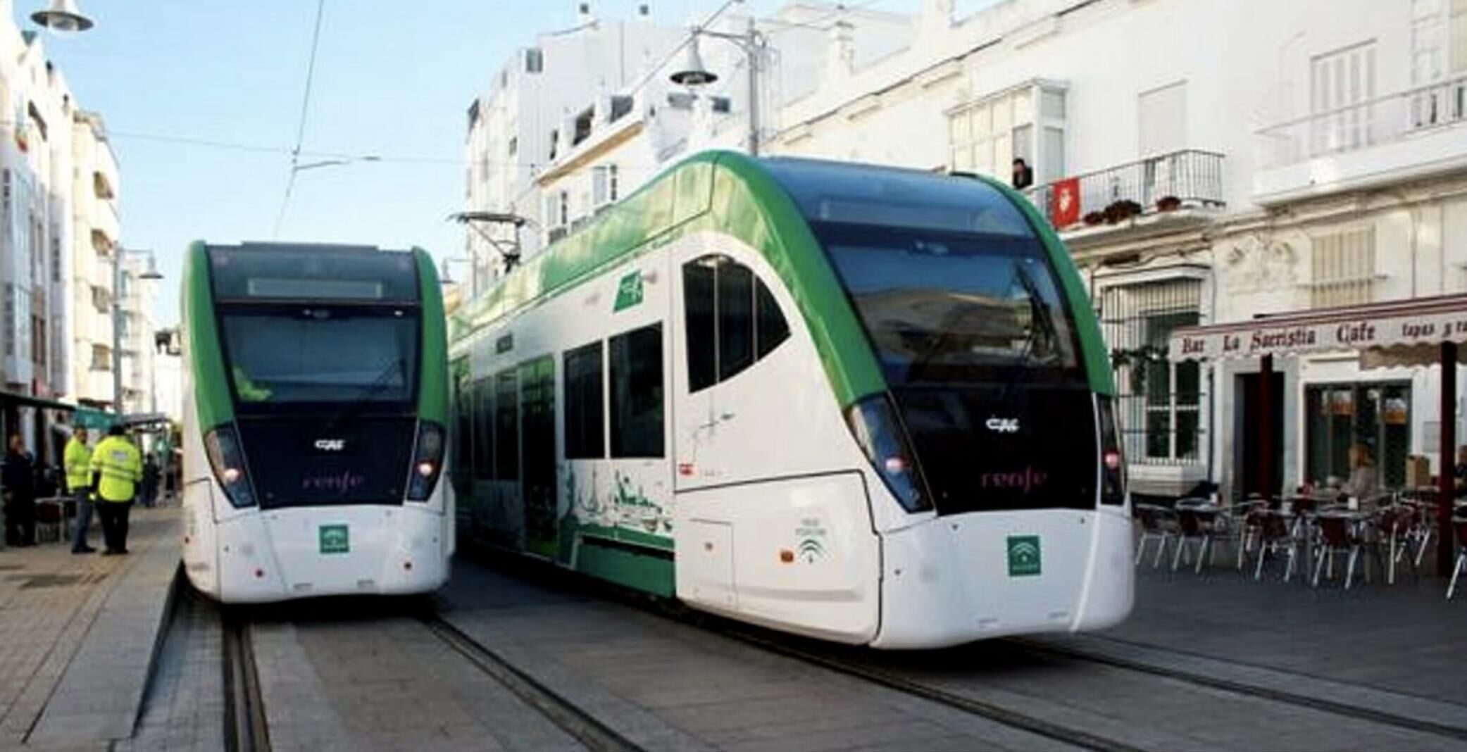 Two modern trams on tracks in an urban setting.