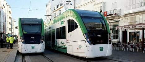 Two modern trams on tracks in an urban setting.