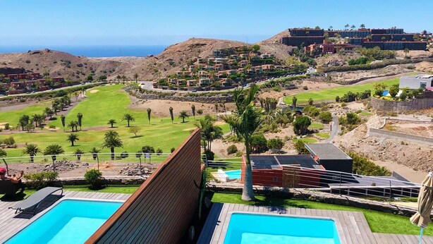 A resort with multiple swimming pools, a golf course, and a view of the ocean. - Amazing Sunset Golf-course Villa for up to 7 (San Bartolomé de Tirajana)