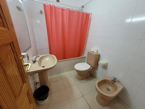 A bathroom with a sink, toilet, bidet, and a shower curtain. - 1 Bed Apartment - Sleeps 2 - Pool - Parking (Arona)
