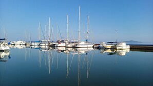 A marina with multiple sailboats docked, calm water, and a clear sky. - Beachfront House,sea Views Near Historic Cartagena (Cartagena)