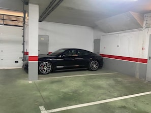Eine Parkgarage mit einem schwarzen Auto in einem Stellplatz.