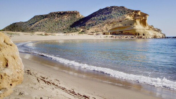 A beach with clear waters, sandy shore, and rocky cliffs. - Noa is out Sailing, so no More Rentals Sorry (Pulpi)