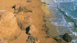 A coastal area with buildings, a sandy beach, and rocky cliffs. - Noa is out Sailing, so no More Rentals Sorry (Pulpi)
