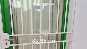 A door with a metal security gate, measuring 83-85 cm, and a green frame. - Noa is out Sailing, so no More Rentals Sorry (Pulpi)