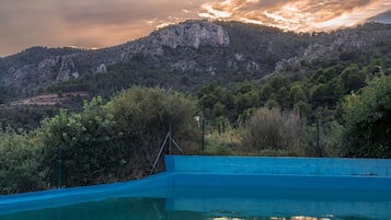 A swimming pool with a view of a mountainous landscape.