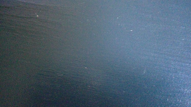 A dark, textured floor surface.