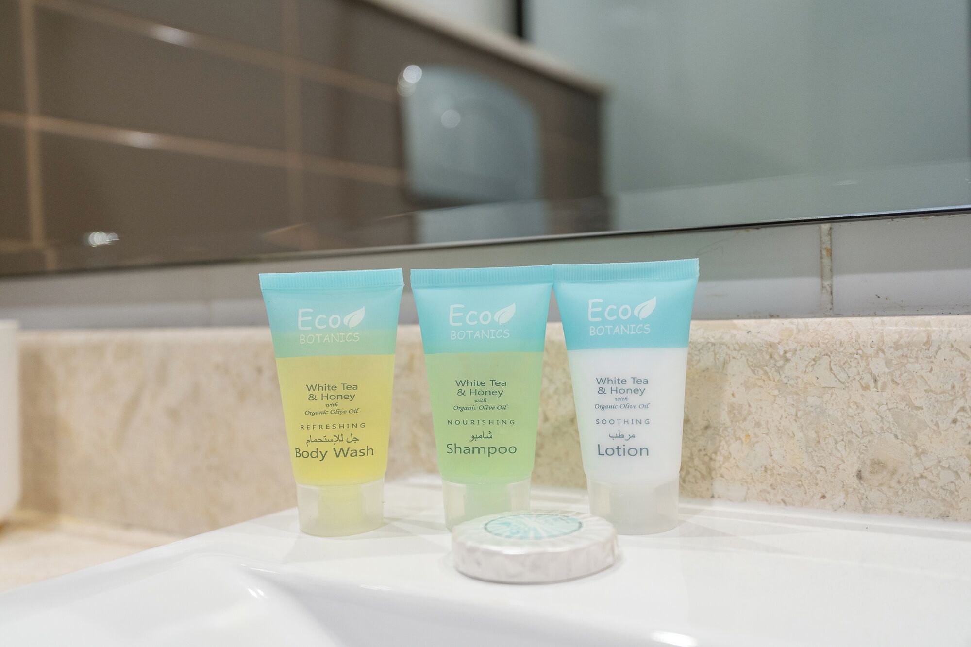 Three Eco Botanics products: White Tea & Honey with Organic Olive Oil Body Wash, Shampoo, and Lotion.