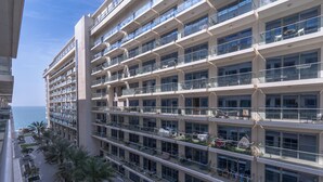 A high-rise hotel with multiple balconies, large windows, and a view of the sea. - NEW Listing Just Renovated Beach Laguna (Ras Al Khaimah)