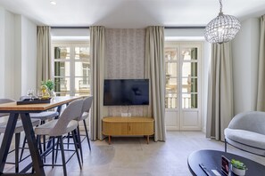 Departamento de diseñador, 1 habitación, para no fumadores, vista a la ciudad | Área de sala de estar | Smart TV de 40 pulgadas con canales por cable