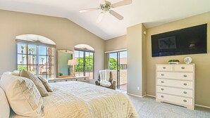 A bedroom with a large bed, a ceiling fan, a dresser, and a TV mounted on the wall. - Patio & Pool Access: Lake Havasu City Gem (Lake Havasu City)