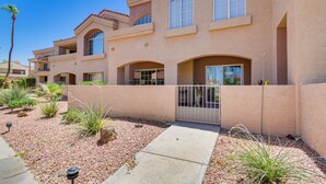 A multi-story residential building with a beige exterior, arched windows, and a gated entrance. - Patio & Pool Access: Lake Havasu City Gem (Lake Havasu City)