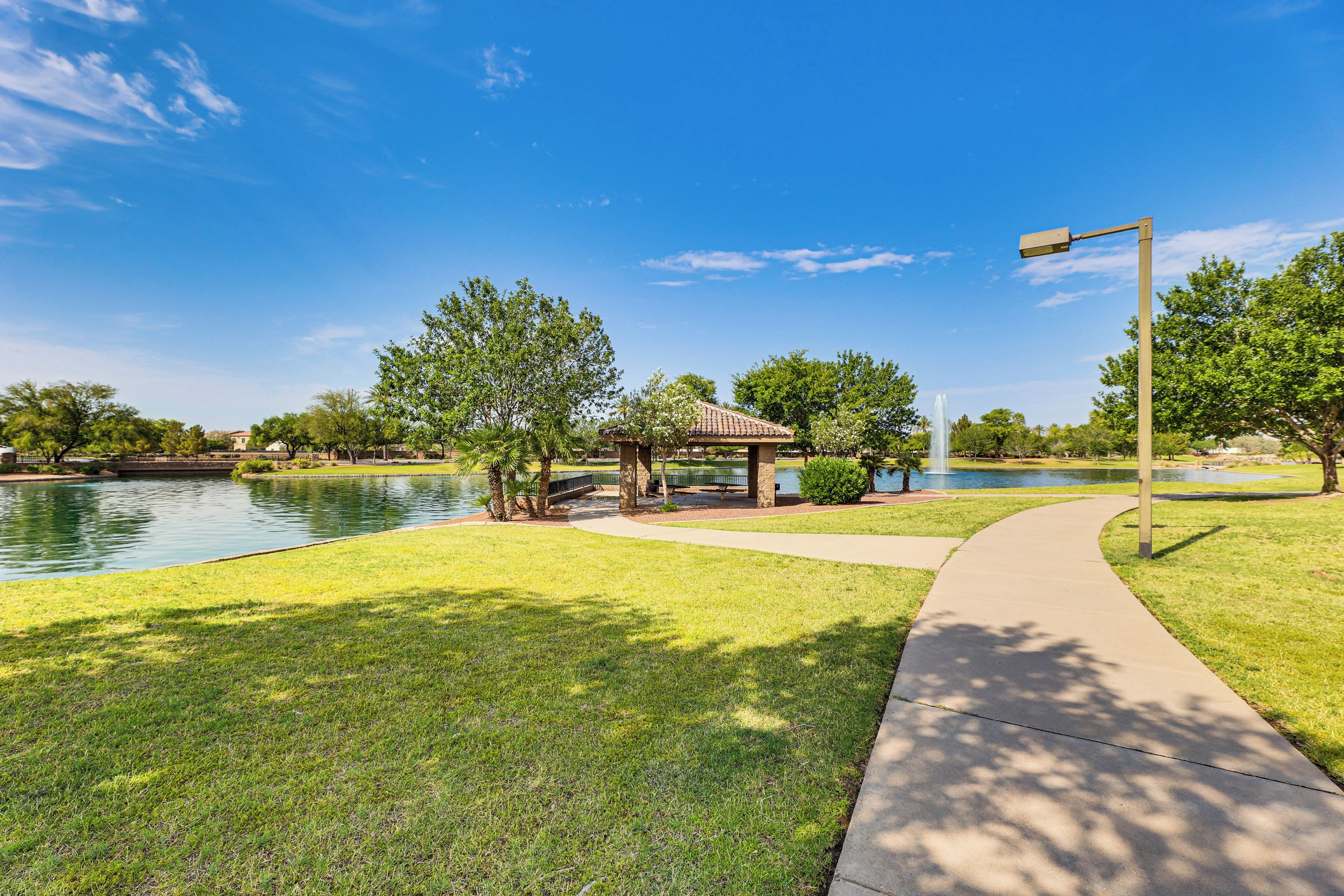 A park with a gazebo, a pond, and a walking path.