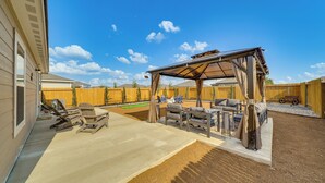 A covered patio area with outdoor furniture, a pergola, and a fenced backyard. - Lovely San Antonio Vacation Rental w/ Private Yard (San Antonio)