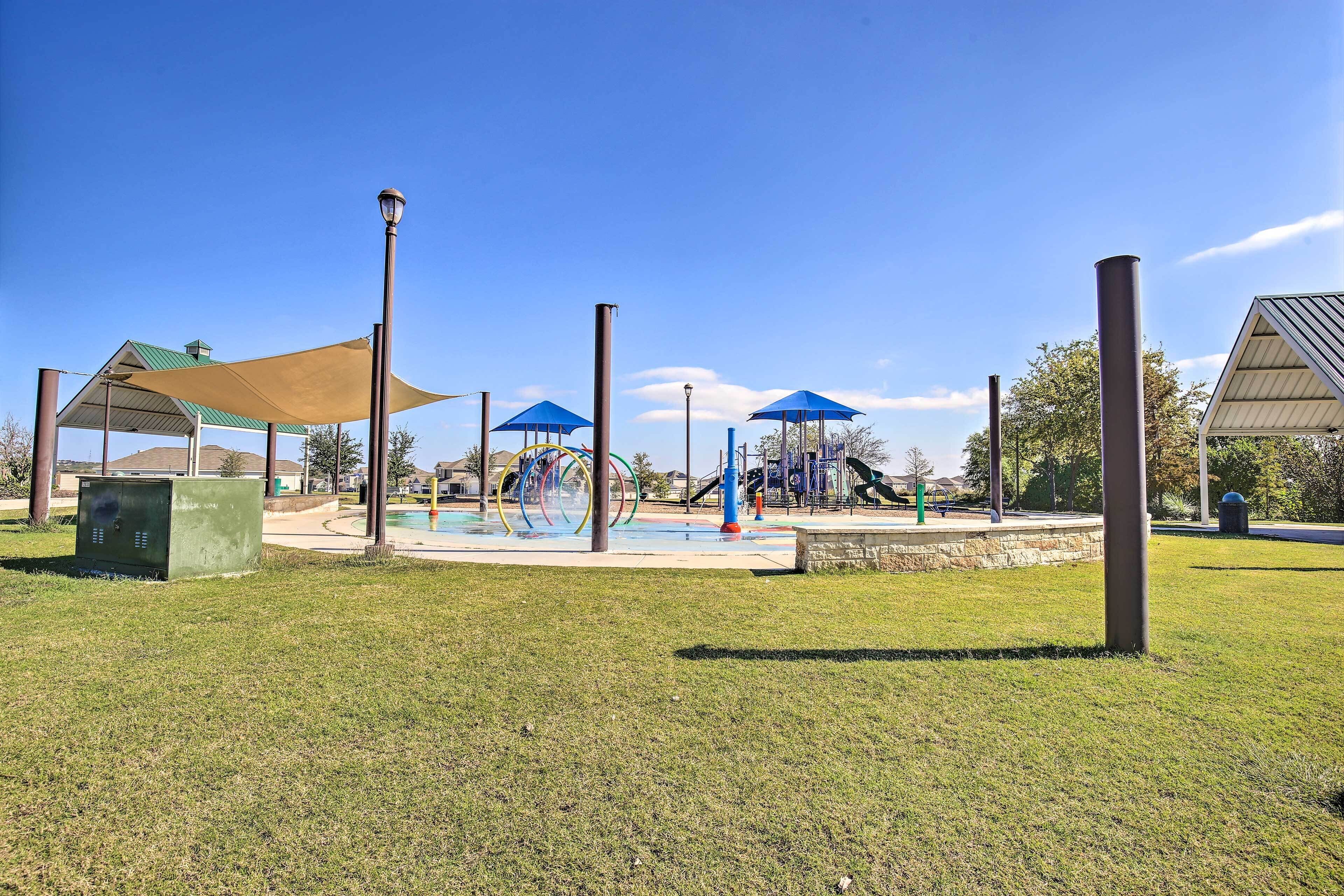 A park with a playground, shaded areas, and a covered seating area.