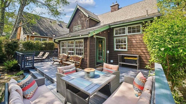 A patio area with outdoor furniture, a table, and a seating arrangement. - High Jinks - New Listing! (Cannon Beach)