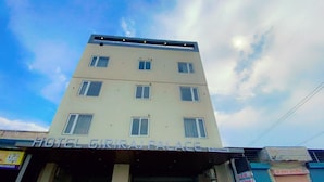 A multi-story building with the sign "HOTEL GIRAJ PALACE" and a partially visible name "By Givindam". - Hotel Giriraj Palace (Jaipur)
