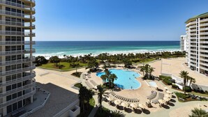 A resort with a large pool, beach access, and multiple balconies. - Spacious Condo with Private Beach Access and Stunning Gulf and Resort Views (Destin)