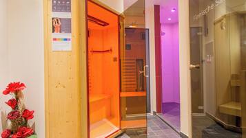 Relax in a serene sauna room with a bathtub, bench, and calming decor.