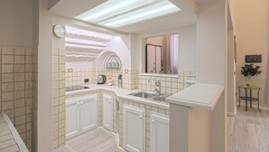 A modern kitchen with white cabinets, a built-in sink, and a countertop. - Giglio Bianco (Florence)