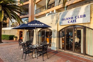 Island Club Café features a modern design with a flat roof and balcony.