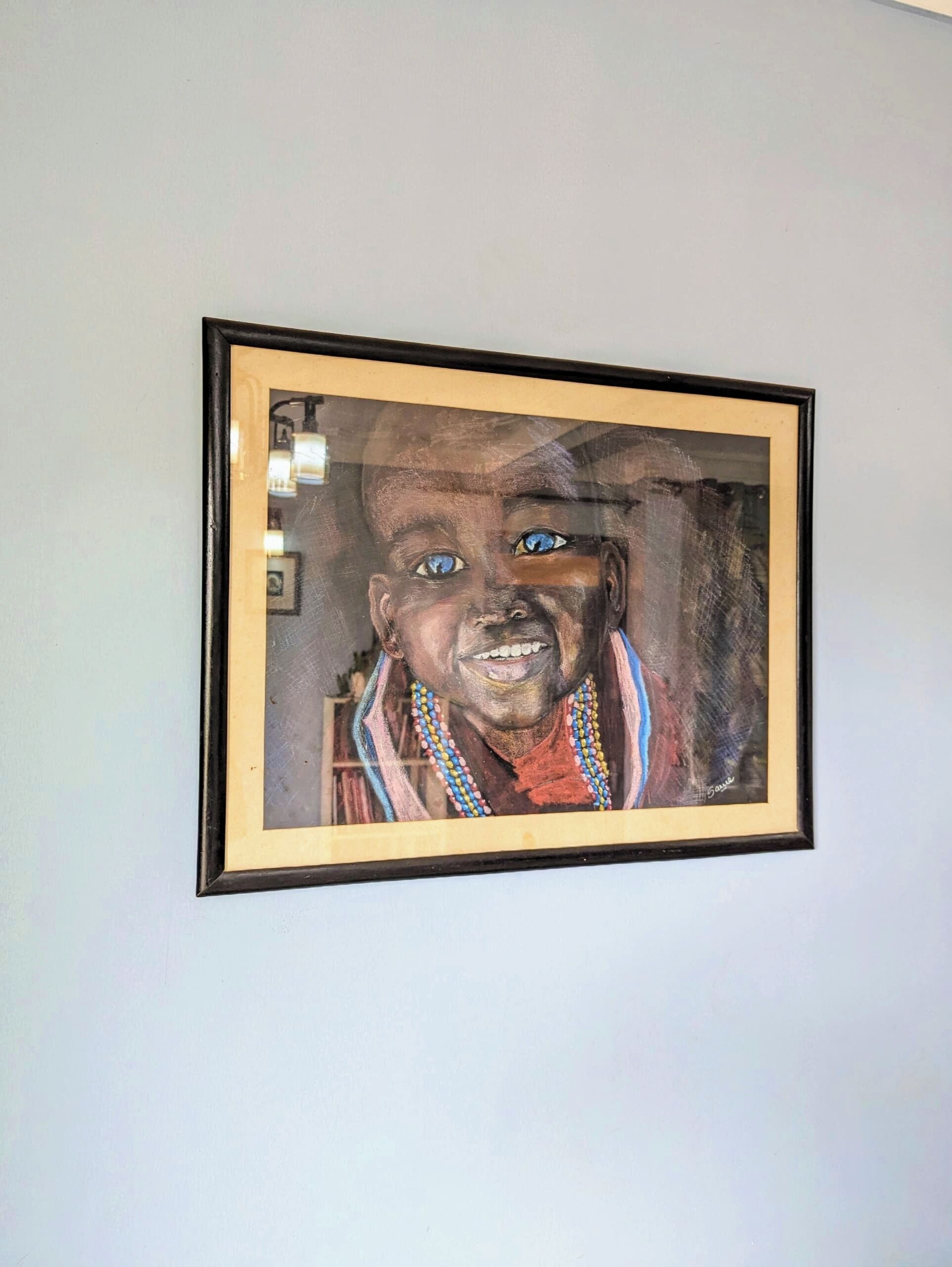 A framed artwork on a wall.