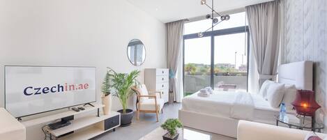 Comfort Studio, Balcony, City View | Living area | 50-inch Smart TV with cable channels