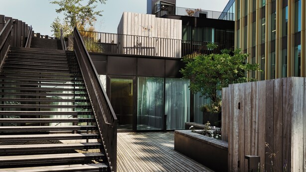 A modern outdoor staircase leading to a wooden deck with a view of a building. - Edgar Suites Lille - Shake  (Lille)