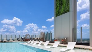 A rooftop pool with white lounge chairs and a view of the ocean. - Atlanta Margaritaville 2 Bedroom Deluxe! (Atlanta)