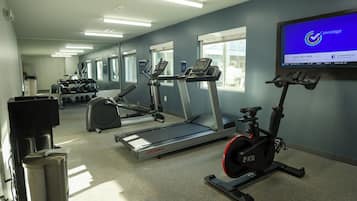 A gym with treadmills, an elliptical, and a stationary bike.