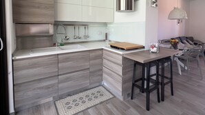 A modern kitchen with a built-in stove, white cabinets, and a wooden countertop. - Welcome to Villa Lodo - The Perfect Retreat for Couples   (Sicilia)