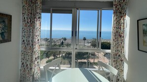 A room with a large window offering a view of the sea and beach. - TERRASOL FRONTAL AL MAR ANTILLAS 8 (Torre del Mar)