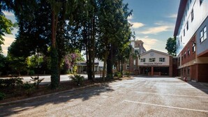 A parking lot with trees and a building labeled "Westone Manor." - Weston Manor (Bicester)
