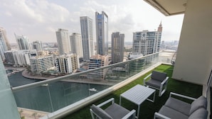 A balcony with a view of a cityscape and a river.