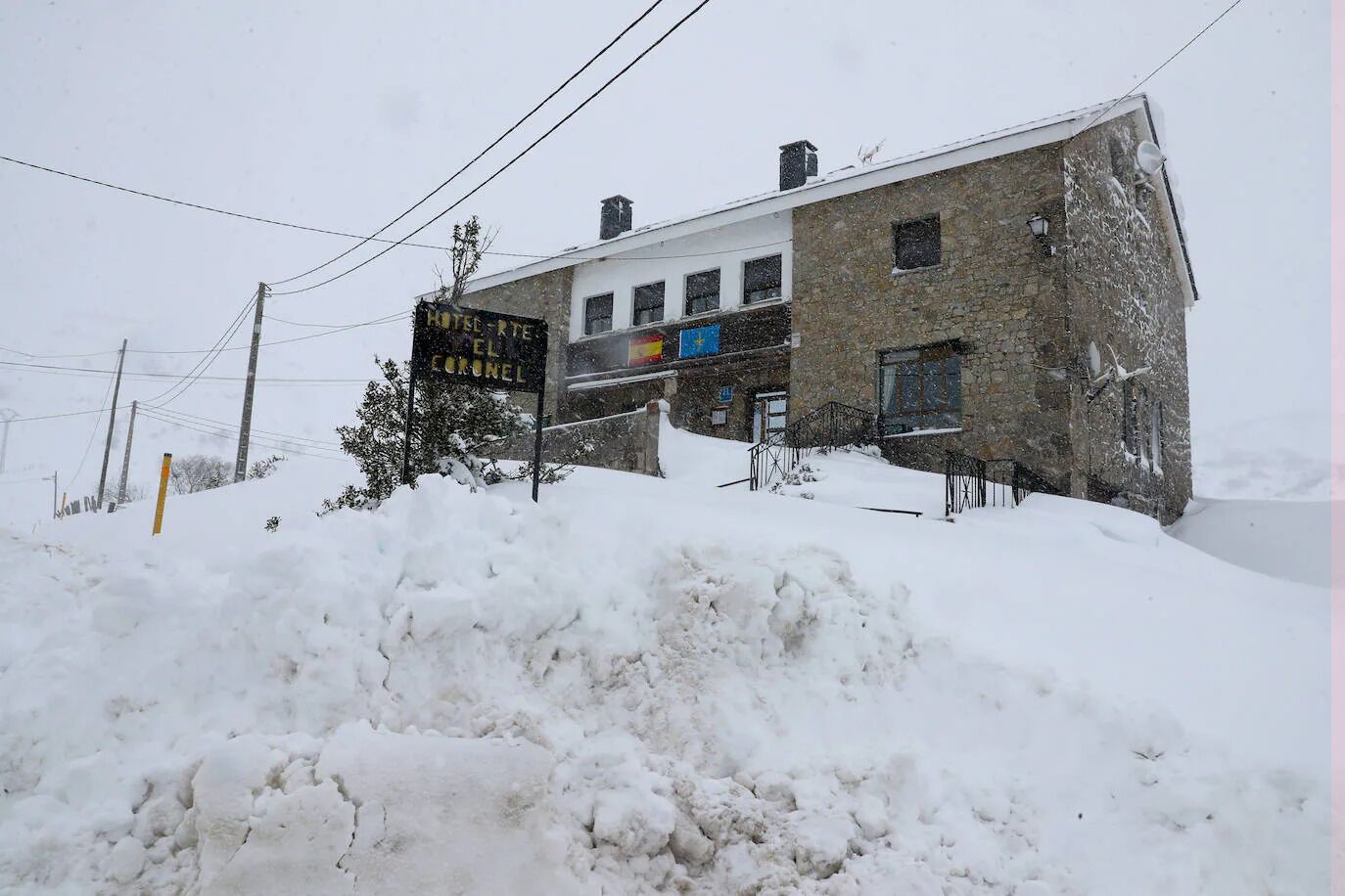 A two-story building with a sign indicating it is a hotel.