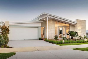 A modern house with a garage, a well-maintained lawn, and a large window. - The Indiana A Space to Relax (Dunsborough)