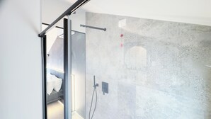 A modern bathroom with a glass shower enclosure, patterned tiles, and a visible towel rack. - Graceful Apartments Hell Apartment by Ca-Sa Check (Chioggia)