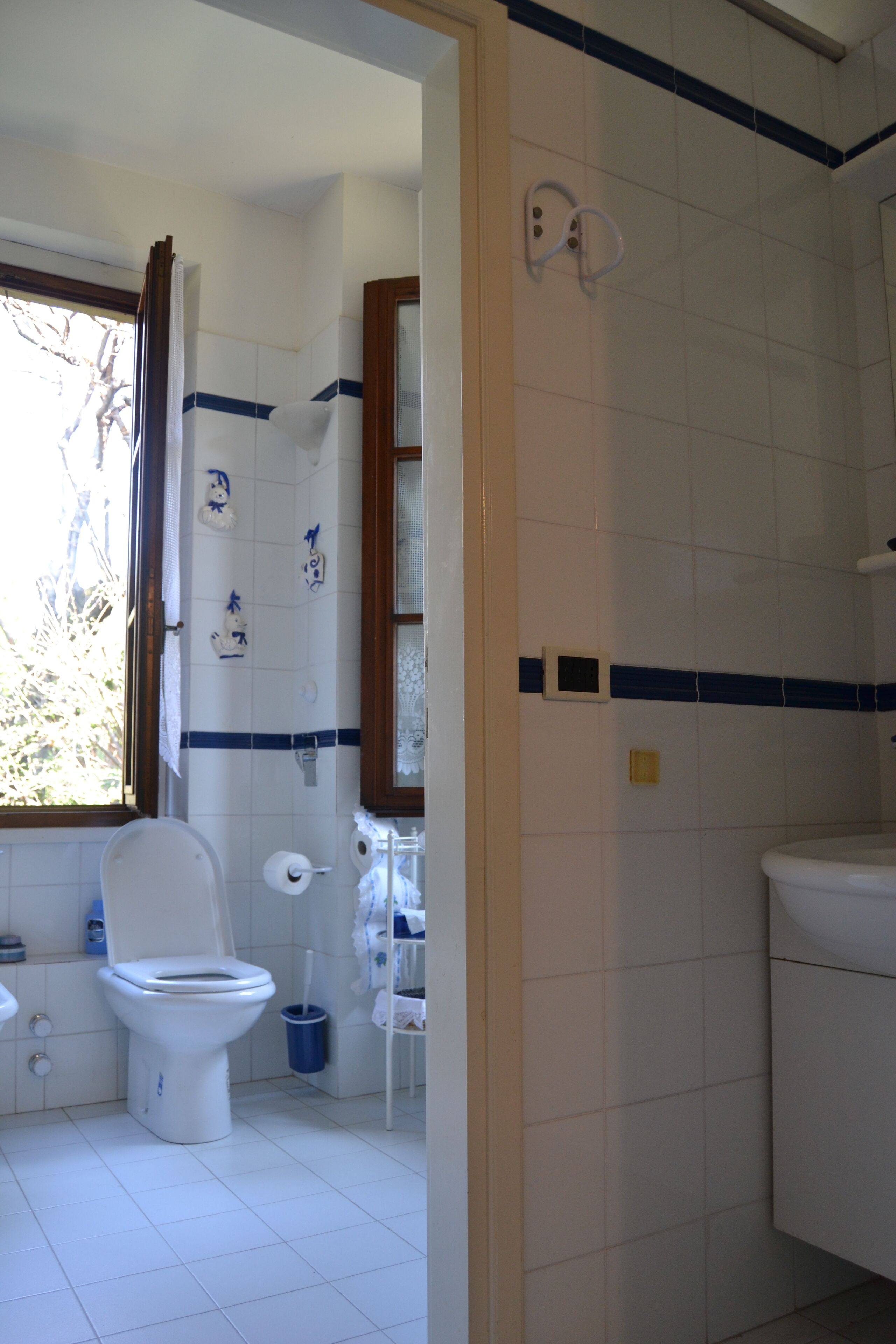 A bathroom with a toilet, bidet, and a shower area.