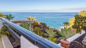 A balcony with a view of the ocean, featuring various plants and a terracotta pot. - Exclusive Sea Views Villamar - Big Terrace & Pool (Costa Adeje)