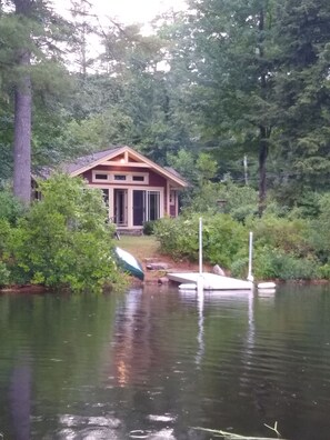 A house by a lake with a dock and a boat. - Cabin & Sauna on Lake Monomonac near Mt. Monadnock (Rindge)