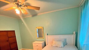A bedroom with a bed, a nightstand, a dresser, a ceiling fan, and a mirror. - Beach Block! 1 bedroom condo!Perfect for 2 people.Must be 25 years old to stay. (Seaside Heights)
