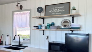 A kitchen with a sink, a refrigerator, and a window with a view. - Newly renovated kitchenette. The Cozy cottage at the Marion County Lake. (Marion)