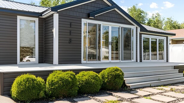 A modern two-story house with a covered porch, large windows, and a well-maintained garden. - ✨ The Dream Cottage– Sea front w/ Hot Tub & Sunset Views - near Parlee Beach (Shediac)