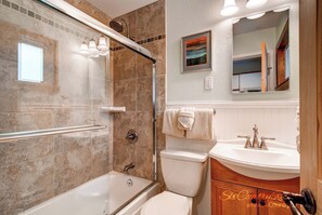 A bathroom with a glass-enclosed shower, a white sink, and a toilet. - Budget-Friendly Top Floor Unit in Downtown - Walk to Shopping/Dining | PM7B (Breckenridge)