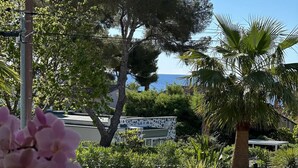 A patio area with outdoor seating, surrounded by lush greenery and trees. - METERS FROM THE MEDITERRANEAN AMID ST. TROPEZ & ST. MAXIM (Roquebrune-sur-Argens)
