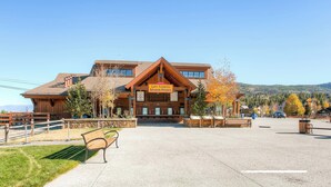A lodge with a sign for lift tickets and season passes, a covered outdoor seating area, and a view of the surrounding mountains. - Unbelievable Downtown, Walk Everywhere. Pet Friendly! Private Hot Tub! SCC4 (Breckenridge)