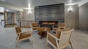 A modern living room with a fireplace, comfortable seating, and a stone accent wall. - Ideal Breck Location, Mountain Views, Wi-Fi, Garage Parking TE405 (Breckenridge)